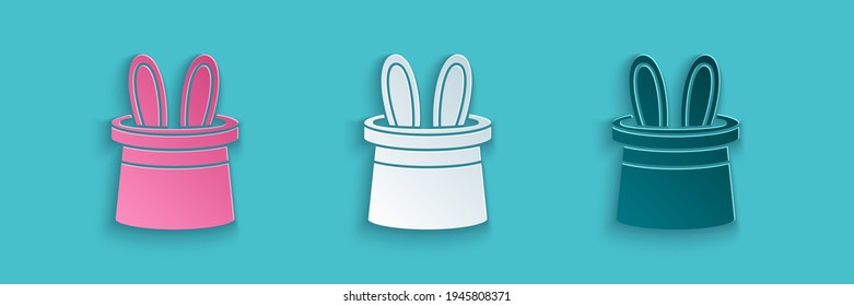 Paper cut Magician hat and rabbit ears icon isolated on blue background. Magic trick. Mystery entertainment concept. Paper art style. Vector