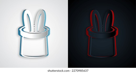 Paper cut Magician hat and rabbit ears icon isolated on grey and black background. Magic trick. Mystery entertainment concept. Paper art style. Vector
