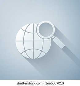 Paper cut Magnifying glass with globe icon isolated on grey background. Analyzing the world. Global search sign. Paper art style. Vector Illustration