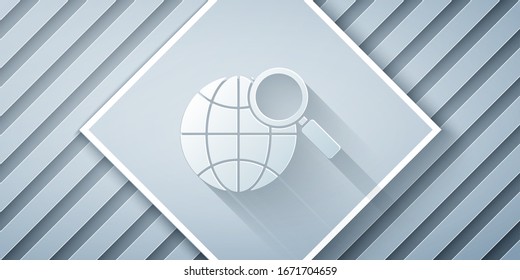 Paper cut Magnifying glass with globe icon isolated on grey background. Analyzing the world. Global search sign. Paper art style. Vector Illustration