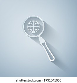 Paper cut Magnifying glass with globe icon isolated on grey background. Analyzing the world. Global search sign. Paper art style. Vector Illustration