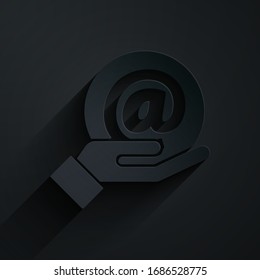 Paper cut Mail and e-mail in hand icon isolated on black background. Envelope symbol e-mail. Email message sign. Paper art style. Vector Illustration
