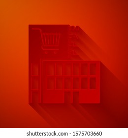 Paper cut Mall or supermarket building with shopping cart icon isolated on red background. Shop or store. Paper art style. Vector Illustration