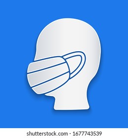 Paper cut Man face in a medical protective mask icon isolated on blue background. Quarantine. Paper art style. Vector Illustration