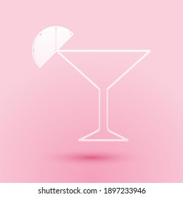 Paper cut Martini glass icon isolated on pink background. Cocktail with lime symbol. Paper art style. Vector.