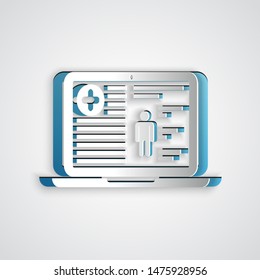 Paper cut Medical clinical record on laptop icon isolated on grey background. Health insurance form. Prescription, medical check marks report. Paper art style. Vector Illustration