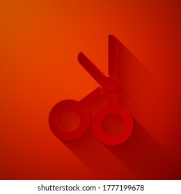Paper cut Medical scissors icon isolated on red background. Paper art style. Vector Illustration