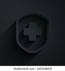 Paper cut Medical shield with cross icon isolated on black background. Protection, safety, password security. Paper art style. Vector Illustration