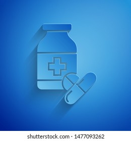 Paper cut Medicine bottle and pills icon isolated on blue background. Bottle pill sign. Pharmacy design. Paper art style. Vector Illustration Paper cut Medicine bottle and pills icon isolated on blue background. Bottle pill sign. Pharmacy design. Paper art style. Vector Illustration