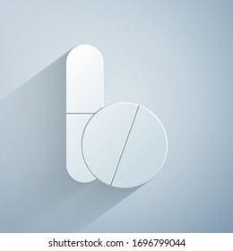 Paper cut Medicine pill or tablet icon isolated on grey background. Corona virus 2019-nCoV. Capsule pill and drug sign. Pharmacy design. Paper art style. Vector Illustration