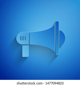 Paper cut Megaphone icon isolated on blue background. Loud speach alert concept. Bullhorn for Mouthpiece scream promotion. Paper art style. Vector Illustration