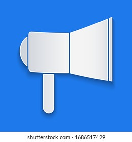 Paper cut Megaphone icon isolated on blue background. Speaker sign. Paper art style. Vector Illustration