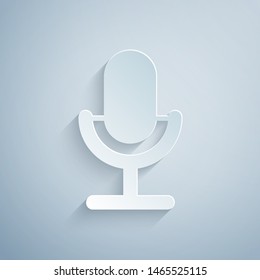 Paper cut Microphone icon isolated on grey background. On air radio mic microphone. Speaker sign. Paper art style. Vector Illustration