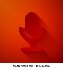 Paper cut Microphone icon isolated on red background. On air radio mic microphone. Speaker sign. Paper art style. Vector Illustration