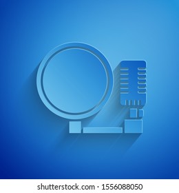 Paper cut Microphone icon isolated on blue background. On air radio mic microphone. Speaker sign. Paper art style. Vector Illustration