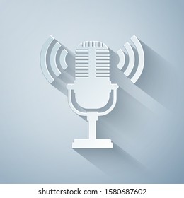 Paper cut Microphone icon isolated on grey background. On air radio mic microphone. Speaker sign. Paper art style. Vector Illustration