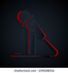 Paper cut Microphone icon isolated on black background. On air radio mic microphone. Speaker sign. Paper art style. Vector Illustration