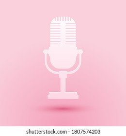 Paper cut Microphone icon isolated on pink background. On air radio mic microphone. Speaker sign. Paper art style. Vector.
