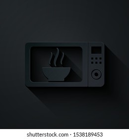 Paper cut Microwave oven icon isolated on black background. Home appliances icon. Paper art style. Vector Illustration