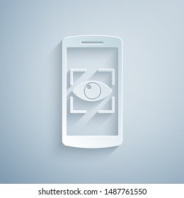 Paper cut Mobile phone and eye scan icon isolated on grey background. Scanning eye. Security check symbol. Cyber eye sign. Paper art style. Vector Illustration