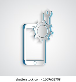 Paper cut Mobile phone with screwdriver and wrench icon isolated on grey background. Adjusting, service, setting, maintenance, repair. Paper art style. Vector Illustration