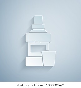 Paper cut Mouthwash plastic bottle and glass icon isolated on grey background. Liquid for rinsing mouth. Oralcare equipment. Paper art style. Vector.