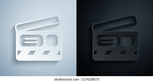 Paper cut Movie clapper icon isolated on grey and black background. Film clapper board. Clapperboard sign. Cinema production or media industry. Paper art style. Vector