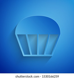 Paper cut Muffin icon isolated on blue background. Paper art style. Vector Illustration