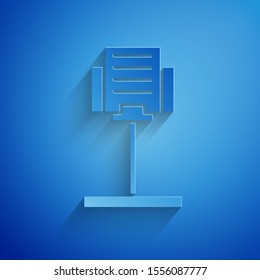 Paper cut Music stand icon isolated on blue background. Musical equipment. Paper art style. Vector Illustration