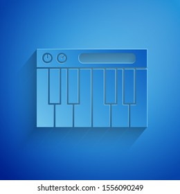 Paper cut Music synthesizer icon isolated on blue background. Electronic piano. Paper art style. Vector Illustration