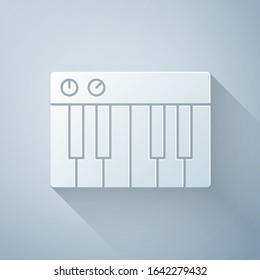 Paper cut Music synthesizer icon isolated on grey background. Electronic piano. Paper art style. Vector Illustration