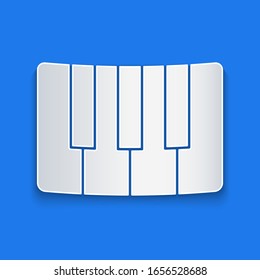 Paper cut Music synthesizer icon isolated on blue background. Electronic piano. Paper art style. Vector Illustration