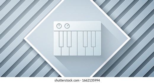Paper cut Music synthesizer icon isolated on grey background. Electronic piano. Paper art style. Vector Illustration