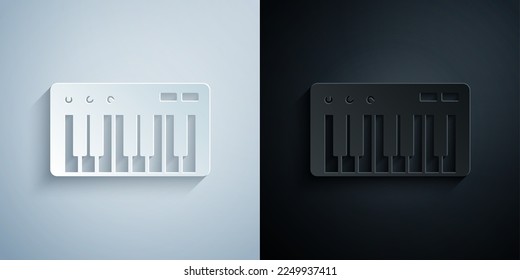 Paper cut Music synthesizer icon isolated on grey and black background. Electronic piano. Paper art style. Vector