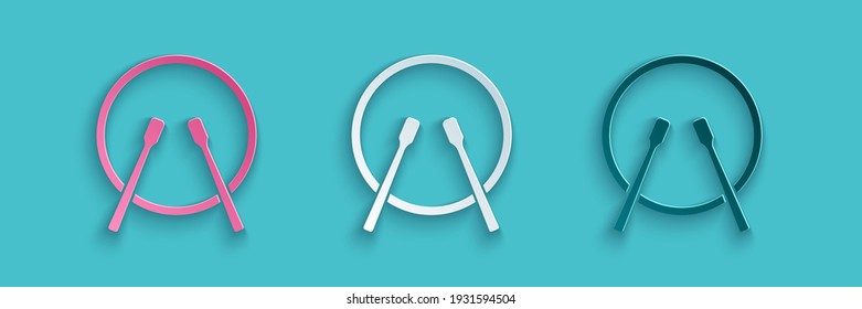 Paper cut Musical instrument drum and drum sticks icon isolated on blue background. Paper art style. Vector
