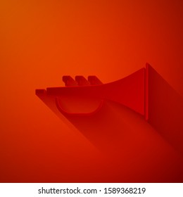 Paper cut Musical instrument trumpet icon isolated on red background. Paper art style. Vector Illustration