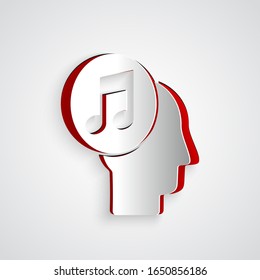 Cortado de papel Nota musical en el icono de cabeza humana aislado en fondo gris. Estilo de arte de papel.  Ilustración vectorial