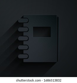 Paper cut Notebook icon isolated on black background. Spiral notepad icon. School notebook. Writing pad. Diary for school. Paper art style. Vector Illustration
