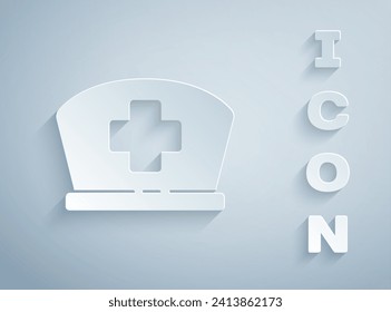 Paper cut Nurse hat with cross icon isolated on grey background. Medical nurse cap sign. Paper art style. Vector Illustration