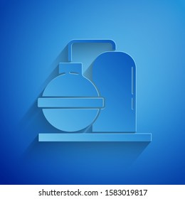 Paper cut Oil and gas industrial factory building icon isolated on blue background. Paper art style. Vector Illustration