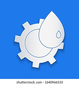 Paper cut Oil and gas industrial factory building icon isolated on blue background. Paper art style. Vector Illustration