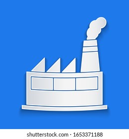 Paper cut Oil and gas industrial factory building icon isolated on blue background. Paper art style. Vector Illustration