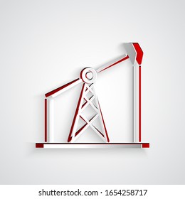 Paper cut Oil pump or pump jack icon isolated on grey background. Oil rig. Paper art style. Vector Illustration