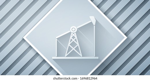 Paper cut Oil pump or pump jack icon isolated on grey background. Oil rig. Paper art style. Vector Illustration