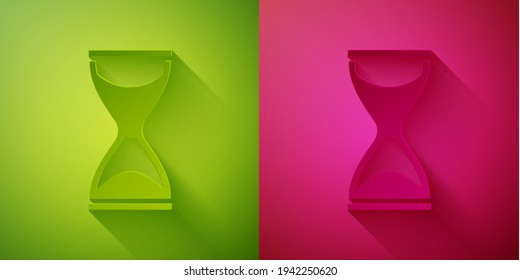 Paper cut Old hourglass with flowing sand icon isolated on green and pink background. Sand clock sign. Business and time management concept. Paper art style. Vector