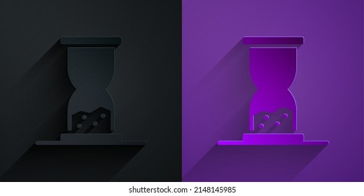 Paper cut Old hourglass with flowing sand icon isolated on black on purple background. Sand clock sign. Business and time management concept. Paper art style. Vector