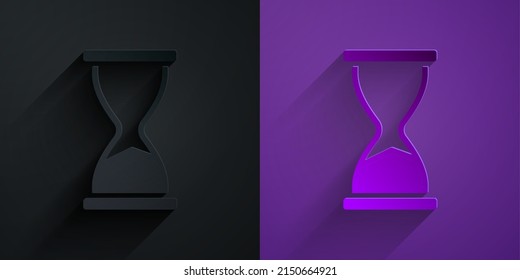 Paper cut Old hourglass with flowing sand icon isolated on black on purple background. Sand clock sign. Business and time management concept. Paper art style. Vector