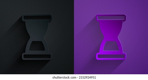 Paper cut Old hourglass with flowing sand icon isolated on black on purple background. Sand clock sign. Business and time management concept. Paper art style. Vector