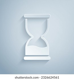 Paper cut Old hourglass with flowing sand icon isolated on grey background. Sand clock sign. Business and time management concept. Paper art style. Vector