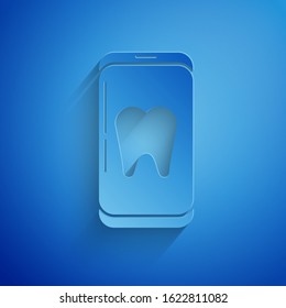 Paper cut Online dental care icon isolated on blue background. Dental service information call center. Paper art style. Vector Illustration